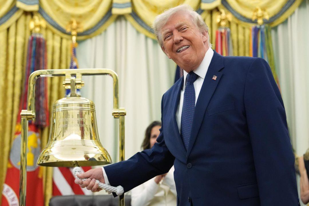 President Trump smiling while ringing a golden bell in the Oval Office on July 6 2026 remotely opening trading at both the NYSE and Nasdaq as the Dow Jones Industrial Average closed above 53000 for the first time in history